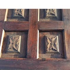 an old wooden door with carved designs on it