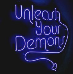 a neon sign that reads unleash your demon