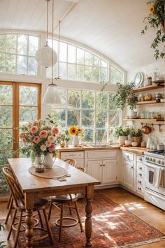 a kitchen filled with lots of furniture and flowers