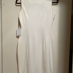 Beautiful Winter White Career Dress. Zipper Feature Is Not Just For Show, They Are Functional. The Dress Is A Poly-Rayon- Spandex Blend, Heavy Weight. Dress Is Below The Knee On My 5’3” Frame, But Is Not True Midi Length. Dress Was Never Worn, It’s Always Been A Bit Too Big. I Saved In Case I Gained Eight Because I Love This Dress. I Hope You Will Love It And Wear It White Sleeveless Stretch Midi Dress, White Bodycon Dress With Back Zipper, Fitted White Bodycon Dress With Back Zipper, White Sheath Dress In Elastane, White Sheath Dress With Back Zipper, Elegant White Mini Dress With Side Zipper, White Sleeveless Elastane Dress, Calvin Klein Knee-length Bodycon Mini Dress, White Dress With Side Zipper For Spring