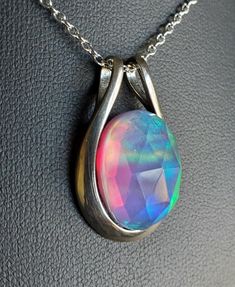 "Amazing Rainbow Aurora Opal Doublet, See Video For Color Spectrum! This Is A Fun Piece, Looks Like Tie Dye! *Stones All Vary Slightly, But Colors And Quality Do Not! 13x18mm Synthetic Opal, 925 Sterling Silver Pendant With 18\" Sterling Silver Chain. Chain Length Options Are Available By Messaging Seller At Time Of Purchase. Gift Box Included." Iridescent Nickel-free Sterling Silver Necklace, Iridescent Gemstone Necklace In Sterling Silver, Iridescent Oval Sterling Silver Jewelry, Iridescent Sterling Silver Round Pendant Necklace, Iridescent Sterling Silver Necklace With Round Pendant, Iridescent Oval Gemstone Necklaces, Iridescent Oval Gemstone Necklace, Faceted Oval Sterling Silver Necklaces, Faceted Oval Sterling Silver Necklace