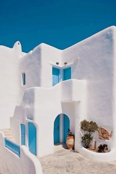 a white building with blue doors and windows