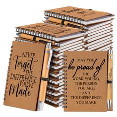 a stack of notebooks and pens with motivational quotes on them