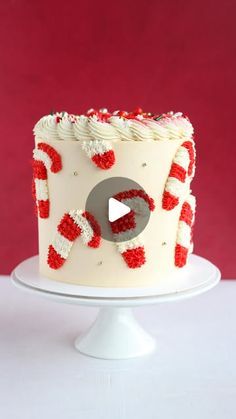 a white cake with red and white decorations