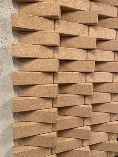 there is a wall made out of cardboard bricks on the side of a building with no one in it