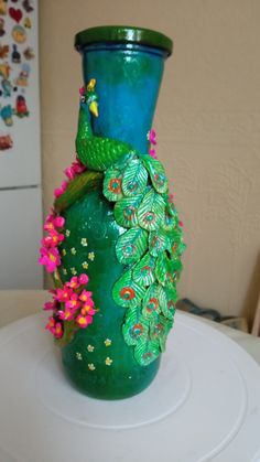 a green vase sitting on top of a white table