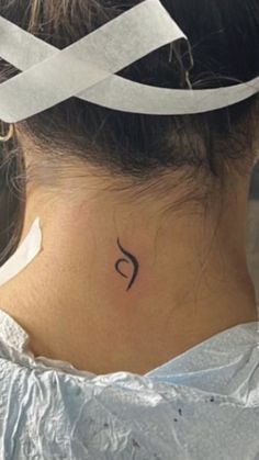 a woman with a tattoo on her neck and behind her head is a white ribbon