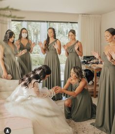 the bridesmaids are getting ready to get into their wedding dress for the ceremony