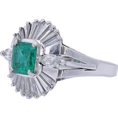 A captivating play of light and luxury unfolds in this exquisite emerald ring, where timeless elegance meets modern sophistication. The centerpiece of this dazzling piece is a lush, 0.80-carat emerald that boasts a mesmerizing depth of color, embodying the lush vibrancy of nature itself. Its radiant green hue is perfectly complemented by the shimmering ensemble of diamonds that surround it. This includes a total diamond weight of 1.10 carats, meticulously set in a dramatic fan-like halo that acc Luxury Solitaire Emerald Ring For Formal Occasions, Timeless Green Diamond Ring, Classic Green Cluster Emerald Ring, Gia Certified Emerald Diamond Ring, Timeless Style, Classic Green Cluster Diamond Ring, Platinum Solitaire Emerald Ring For Formal Occasions, Classic Emerald Ring With Baguette Cut, Elegant Green Cluster Ring With Brilliant Cut, Formal Emerald Cluster Ring For May Birthstone