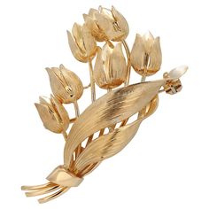 The Tiffany and Co. Yellow Gold Tulip Brooch is a beautiful and elegant piece of jewelry that is sure to be a treasured addition to any collection. This brooch is signed and made of 18kt yellow gold, which gives it a rich and luxurious look. Brooch measures 1.00" w x 1.90" h Signed, "Tiffany & Co. ©18kt Italy" The design of the brooch is inspired by the tulip flower, which is a symbol of beauty and grace. The tulip is a popular motif in jewelry design, and this brooch is a stunning example of th Chanel Flower, Vintage Tiffany, Wax Carving, Tiffany Jewelry, Tulip Flower, Gold Brooches, Tiffany And Co, Pearl Brooch, Gold Floral