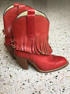 "1970's brick red fringed low height cowboy boots with a great patina by Frye. Estimated Size: US 5.5 Vintage size marked: 6 B Insole: 9\" Width: 3.25\" Heel height: 2.5\" Circa: 1970's Condition: Good vintage condition. Subtle wear, scuffs / marks. SOLD AS-IS. Follow us on Instagram for the latest----> http://instagram.com/closetcasevintage @closetcasevintage Please contact us about any questions you may have regarding condition before purchasing. Read the blog for updates, giveaways and sty Red Western Heeled Boots With Snip Toe, Red Bohemian Boots For Fall, Red Western Heeled Boots With Round Toe, Red Western Style Heeled Boots With Round Toe, Red Heeled Boots For Rodeo In Fall, Red Round Toe Heeled Boots For Rodeo, Red Leather Heeled Boots For Rodeo, Bohemian Red Leather Boots, Vintage Red Boots For Fall