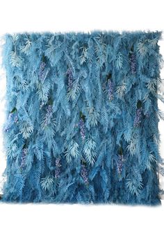 a blue pillow that is made out of feathers and flowers on the back of it