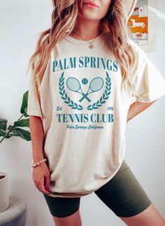 Palm Springs Tennis Club t-shirt. These tees are Comfort Colors and are made to last using premium ringspun cotton, this creates an vintage-soft shirt. The soft-washed, garment-dyed fabric brings extra coziness to your wardrobe while the relaxed fit makes it an excellent daily choice. ✦ 100% Ringspun Cotton ✦ Relaxed fit ✦ Medium fabric ✦ Sewn-in twill label ✦ Eco-friendly, Ethically Made & Sweatshop Free ✦ Printed to order with non-toxic ink ✦ Durable and Long-lasting ✦ Shirts are pre-shrunk bu Sporty Tops With Sublimation Print For Spring, Sporty Spring Shirt With Letter Print, Relaxed Fit Sublimation Print Top For College, Sporty Crew Neck Spring Shirt, Sporty Crew Neck Shirt For Spring, Sporty Screen Print T-shirt For Spring, Spring Sporty Shirt With Text Print, Sporty Shirt With Text Print For Spring, Sporty Spring Shirt With Text Print