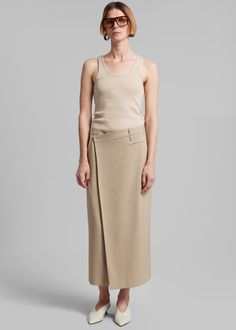 Color: Beige Midweight woven fabric Regular fit Midi length Asymmetrical hem Side seam pocket Illusion welt front pocket Belt loops Hook and bar closure Lined 90% Polyester 2% Elastane Dry Clean By The Frankie Shop. Imported Side Seam Pocket, Classic Trousers, The Frankie Shop, Frankie Shop, Mini Short, Midi Skirts, Pocket Belt, Asymmetrical Hem, Hook And Loop