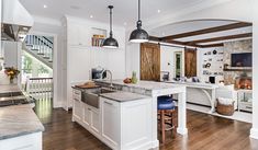 a large kitchen with an island and bar stools