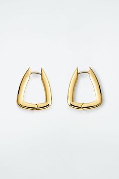 These sculptural hoop earrings drop from the lobe in a softly squared shape. They're made from post-consumer recycled brass that's plated in gold and have a hinged closure for secure wear. Hinge closureBrass is a versatile material that can be recycled numerous times without losing any of its properties Shell: 100% Post-consumer recycled brass. Plating: 100% Gold. Excluding trims Earring length is 0.78" Fendi Sneakers, Studded Belt, Earrings Drop, Accessories Unique, Women Accessories Jewelry, Mules Shoes, Mens Shoes Sneakers, Handbag Accessories, Blue Man