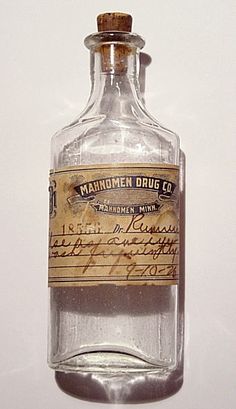 an old fashioned medicine bottle with writing on it