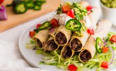 baked turkey and black bean taquitass on a plate with lettuce