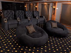 a room filled with black chairs and gold stars on the carpeted floor next to a wall