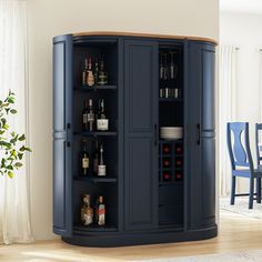 a tall blue cabinet with wine glasses and bottles on it's shelves in a living room