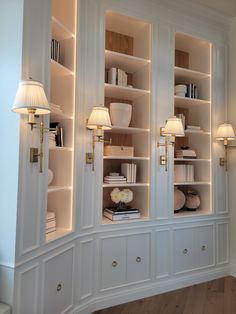 a white bookcase filled with lots of books