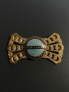 A very nice example of Antique / vintage jewellery.  A French enamel brooch,  with push pull trombone clasp, gilt bronze brooch, blue enamelled decoration. The metal looks like gold but I believe is gilt bronze as I cannot find any hallmarks. Enamel was used on pieces from Limoges? There is a possibility it is from that area of France ?  It has a "push pull clasp" also known as a trombone clasp.  Good vintage or antique condition but please see photos as will naturally have signs of wear and age Formal Blue Enamel Brooches, Collectible Gold Enamel Pins, Art Deco Blue Brooches For Gifts, Art Deco Blue Brooches As Gifts, Vintage Blue Brooch Pin, Antique Blue Enamel Brooches, Antique Blue Collectible Brooches, Gold Enamel Lapel Pin, Gold Enamel Art Nouveau Brooches