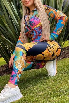 a woman sitting on top of a bench wearing colorful pants