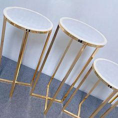 three gold and white tables sitting next to each other