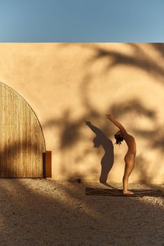 a woman doing yoga in front of a building