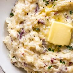 a white bowl filled with mashed potatoes and butter