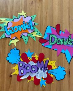 three different types of speech bubbles on a wooden surface with the words comic and boom