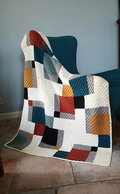 a white blanket sitting on top of a blue chair