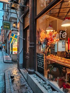 a store front with an assortment of food on display in it's glass window