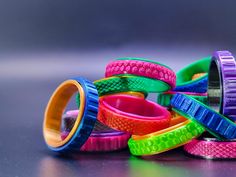 many different colored rubber bracelets stacked on top of each other with one ring in the middle