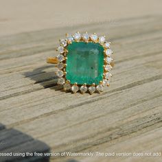 6.80 Carat Real Emerald And Diamond Ring - Octagon Zambian Emerald Ring - 14k Solid Gold Women Gift Ring - Christmas Gift Emerald Ring GEMSTONE DETAILS : ✦ Gemstone : Natural Emerald ✦ Gemstone Size : 13 mm length / 10.60 mm width / 6.70 mm height ✦ Gemstone Shape : Emerald Cut ✦ Number of Gemstones : 1 ✦ Gemstone Weight : 6.80 Carat ✦ Gemstone Grade : AAA DIAMOND DETAILS : ✦ Diamond Type : Natural ✦ Diamond Size : 2.20 MM ✦ Diamond Color : G-H ✦ Diamond Clarity : Slightly included ✦ Diamond Cut : Excellent ✦ Diamond Weight : 0.82 Carat METAL DETAILS : ✦ Metal : 14K/18K /22K Gold ✦ Metal Color : Yellow / White / Rose Gold ✦ Setting : Prong Setting ✦ Box : Yes SHIPPING DETAILS : ✦ Production time : 3-4 days ✦ Delivery time : 7-8 days ✦ Expedited shipping : Available ✦ Expedited shipping ser Fine Jewelry With Certificate Of Authenticity As Gift, Anniversary Diamond Jewelry With Certificate Of Authenticity, Fine Jewelry As A Gift With Certificate Of Authenticity, Fine Jewelry Gift With Certificate Of Authenticity, Octagon-shaped Emerald Diamond Anniversary Ring, Cluster Emerald Ring For Gift, Cluster Emerald Jewelry For Gift, Emerald Cluster Jewelry Gift, Gift Cluster Emerald Ring