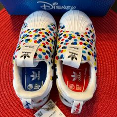 Adidas Disney Mickey & Minnie Superstar Slip On Shoes Size 9 - Brand New W/ Box! Super Cute And Comfy - Made With 50% Recycled Material :) Disney White Low-top Sneakers, Sporty Mickey Mouse Synthetic Sneakers, Black Mickey Mouse Sneakers For Streetwear, White Low-top Mickey Mouse Sneakers, White Disney Sneakers In Synthetic Material, Disney White Sneakers With Mickey Mouse Detail, Disney White Sneakers With Mickey Mouse, Disney Themed Slip-on Sneakers For Disney Trips, White Disney Mickey Mouse Sneakers