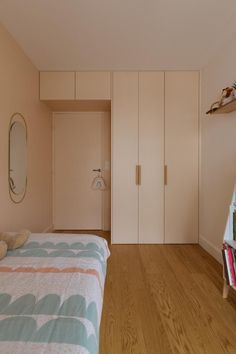 a bedroom with a bed, bookshelf and mirror