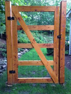 an open wooden gate in the grass