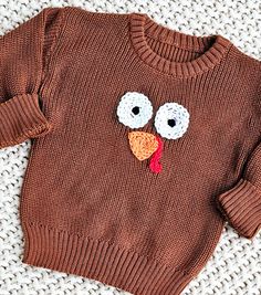 a brown sweater with a turkey face on it