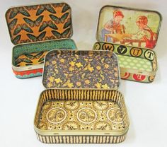 four tins with different designs on them