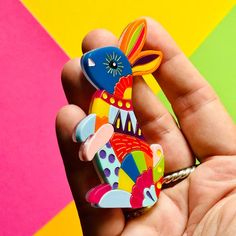 a person holding a colorful toy in their hand