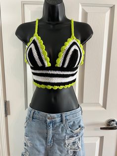 🖤🤍 BEETLEJUICE, BEETLEJUICE...it's SHOWTIME! 🤍🖤 Be a strange and unusual in this perfect Beetlejuice inspired black, white and lime green crochet crop top. The perfect outfit to read the Handbook for the Recently Deceased.  Jam out and dance to the Banana Song in this amazing Beetlejuice crocheted shirt that you will most definitely stand out in a crowd!  Perfect for a summer music festival, farmers market, concert, food festival or just a stunning piece for the boho style. Not to mention the BEST SHIRT to watch the original or the newest movie!  Shirt is not lined but tight crochet pattern allows for little to no show through. Such a gorgeous, one of a kind shirt! The Beetlejuice fan can make a huge statement with this piece of fashion!  Criss-Cross tie is single crocheted for a comfo Beetlejuice Crochet Top, Black Summer Cosplay Top, Stretch Tops For Summer Cosplay, Summer Stretch Tops For Cosplay, Fitted Rave Tops For Halloween, Fitted Rave Top For Cosplay, Rave Style Fitted Top For Cosplay, Fitted Cotton Top For Costume Party, Fitted Tops For Halloween Costume Party