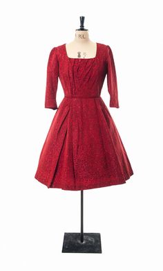 This dress is a real find.  An original 1950s, it has been incredibly well looked after.  I purchased this dress from the original owner, who remembers having it made for herself. It is made in sumptuous red and black brocade, with black lining. The dress is well cut, with pleating detail on the skirt and neckline, and bracelet length sleeves with darts at the elbows.  The quality of the fabric and the workmanship stands out, with beautiful piped detail at the waist. It is in robust wearable con Red Fitted Brocade Dress, Vintage Brocade Party Dress, Red 1950s Style Evening Dress, Red Brocade Party Dress, Red Vintage Dress For Vintage Events, Red Vintage Dress For Formal Occasions, Vintage Brocade Fitted Dress, Red Vintage Evening Dress, Fitted Vintage Brocade Dress