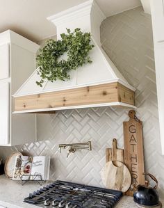 a stove top oven sitting inside of a kitchen next to a wall mounted range hood