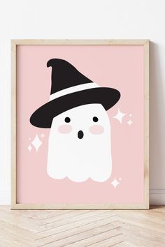 a pink and black poster with a white ghost wearing a witches hat on it's head