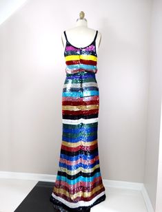 "Such a colorful dress! It's fully embellished with bright sequins in a horizontal stripe design. There are a few blue sequins missing on the back. Otherwise, it's in excellent condition! Measurements: Bust - 32/34\" Waist - 24/26\" Hips - 34/36\" Length - 62\" Tag Size - Small This dress comes from a pet-free and smoke-free home. If you would like more info or have any questions, please don't hesitate to ask!" Glamorous Multicolor Floor-length Dress, Multicolor Maxi Dress For Evening Parties, Fitted Multicolor Maxi Dress For Party Season, Multicolor Sequined Maxi Dress For Party, Multicolor Sequined Maxi Dress, Embellished Multicolor Maxi Dress For Party, Multicolor Embellished Floor-length Dress, Fitted Multicolor Maxi Dress With Sequins, Glamorous Multicolor Party Maxi Dress