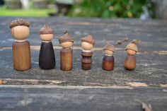 a group of wooden dolls sitting next to each other on top of a picnic table