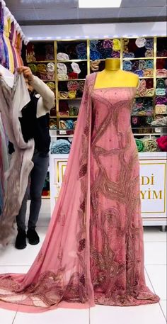 a mannequin is dressed up in a pink dress