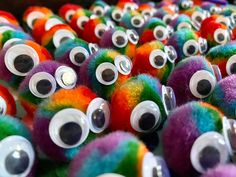 there are many different colored balls with googly eyes