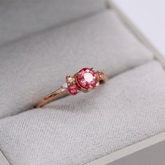 The padparadscha sapphire cluster ring is an expression of pure joy. She gathers created sapphires of varying pink hues and brilliant white lab-created diamonds together into an asymmetrical, sparkling bouquet. At once delicate and intense, this gemstone ring makes the perfect right-hand ring or alternative engagement ring. Details: 14k rose gold .66ct padparadscha created sapphire center .02 total carat weight - lab-grown diamonds .81 total carat weight - created sapphires Pink Ruby Birthstone Ring For Wedding, Pink Cluster Promise Ring In Fine Jewelry Style, Pink Diamond Cluster Ring With Accent Stones, Pink Ruby Ring For Proposal In Fine Jewelry Style, Pink Ruby Ring With Accent Stones For Promise, Pink Sapphire Diamond Ring With Round Cut, Pink Cluster Diamond Ring For Wedding, Pink Cluster Diamond Ring, Pink Diamond Birthstone Ring For Promise